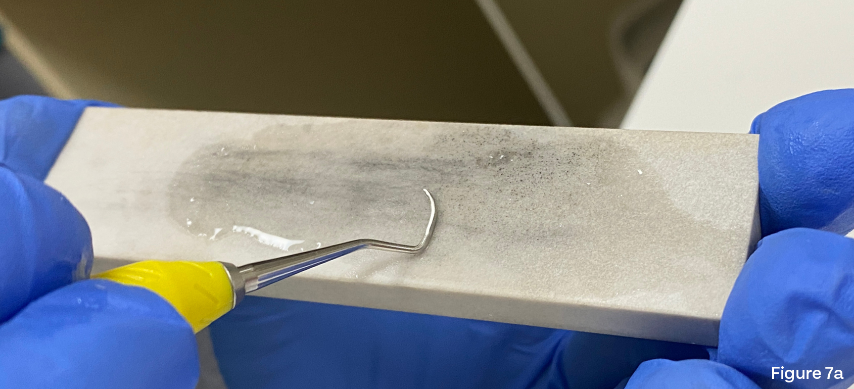 Image showing a curved curette on a sharpening stone