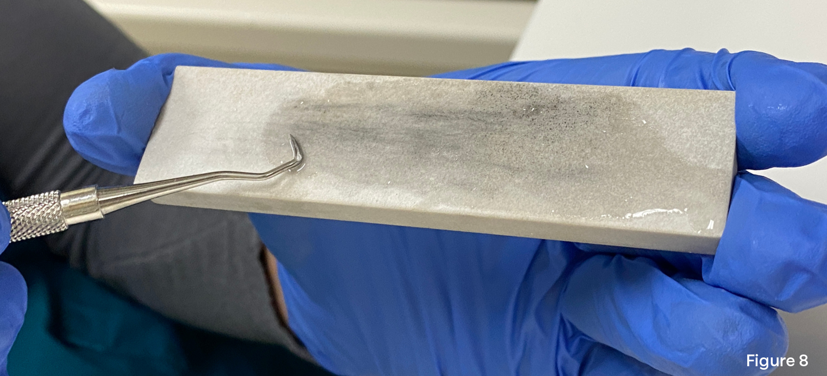 Image showing a curved curette on a sharpening stone