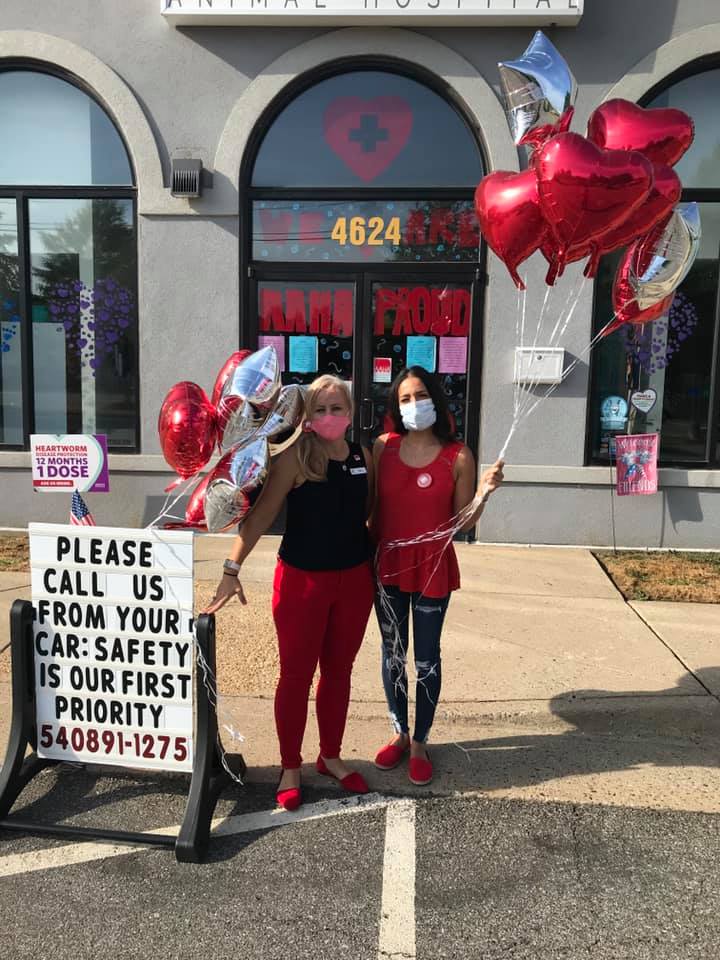 Team members hold balloons outside St. Francis Animal Hospital in Fredericksburg, Virginia.