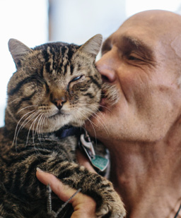 man_kissing_1-eyed_cat_-_Photo_courtesy_of_Feeding_Pets_of_the_Homeless.jpg