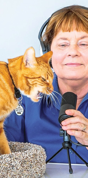 Arden Moore recording a podcast with her cat
