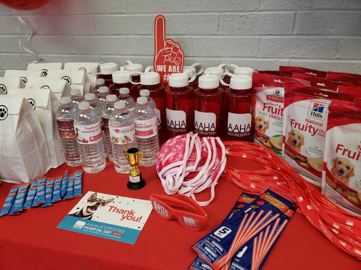 AAHA goodies table at Healthy Pets of Bern-Lor in Grove City, Ohio with pet treats, AAHA water bottles and tie-dyed masks.