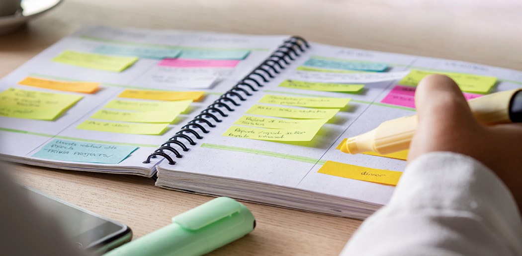 A person is making a list of points in a notebook. The first step to employee retention is identifying the specific components of a solid recruiting and hiring process. 