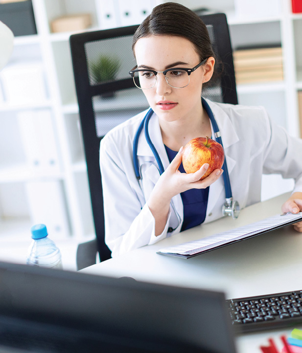 Doctor fitting a snack in between appointments is important for physical wellbeing.