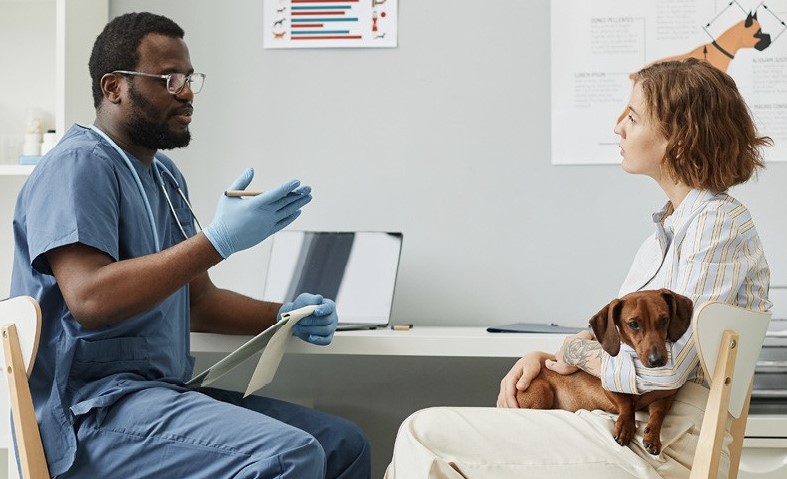 Veterinary technician answering pet owners' questions