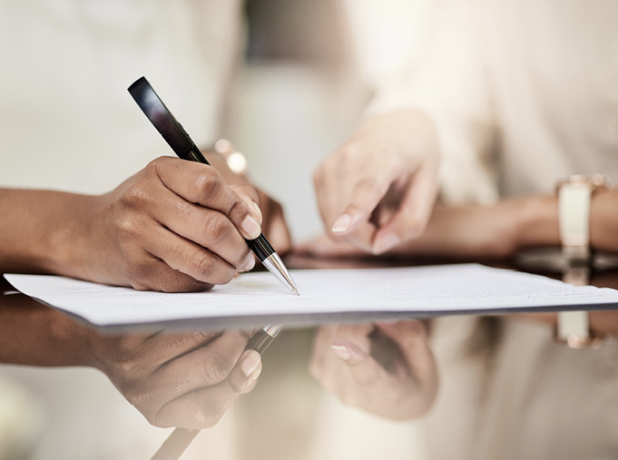 Woman signing a agreement document