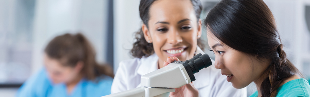 Veterinary technician reading a cytology slide