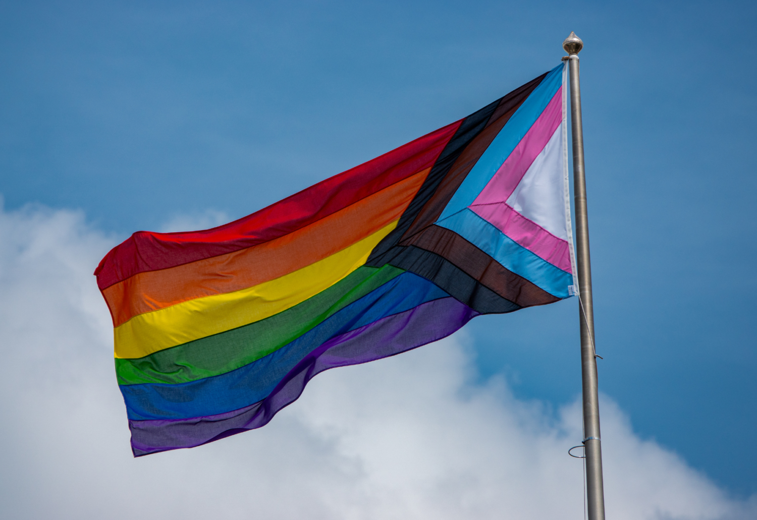A Pride flag waves in the wind