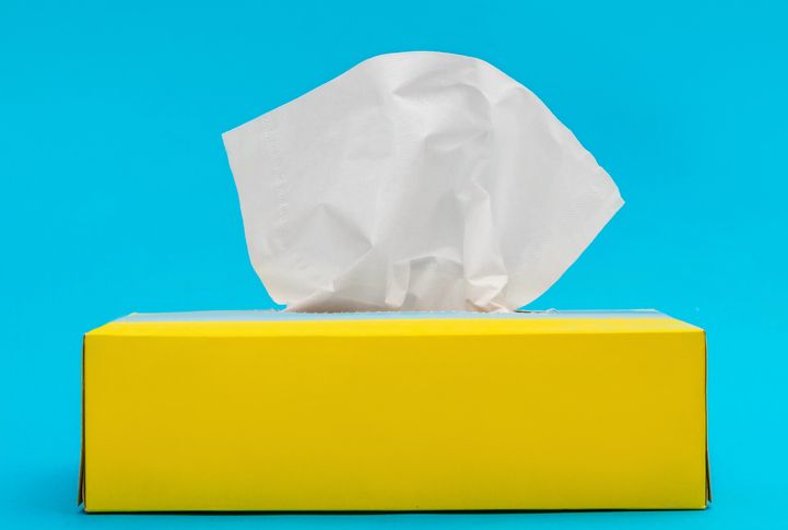 A yellow box of tissues against a blue background