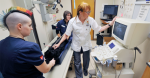 (L to R) Veterinary Assistant Morgan Ellis, Lead Surgical Technician Stephanie Crobar, CVT, and Deah Hessian, DVM, using the ultrasound