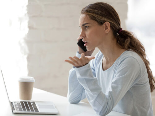 Photo of an angry client on her phone.