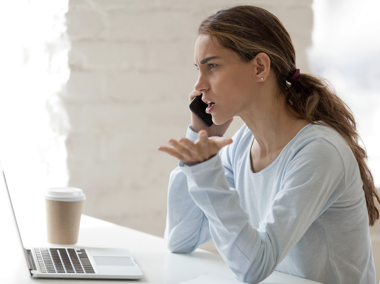 Photo of an angry client on her phone.