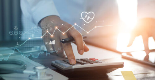 Closeup photo of a doctor using a calculator with an overlay of financial graphs and information to represent practice finance
