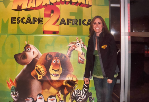 dr. andrea spediacci when she worked at dreamworks, standing in front of a movie poster