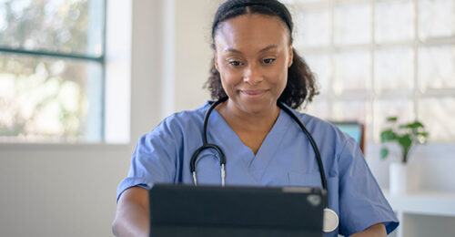 A veterinary technician talking to a client via telehealth.