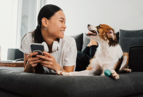 Woman on phone next to dog