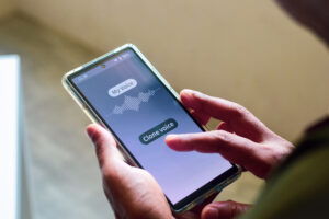 Man using mobile applications for cloning his voice. Selective focus.