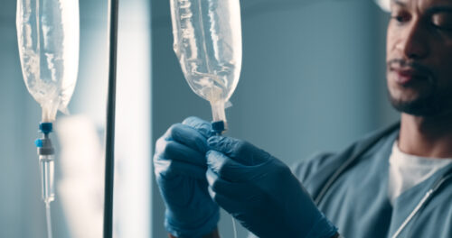 Hospital, iv drip medicine and doctor with gloves