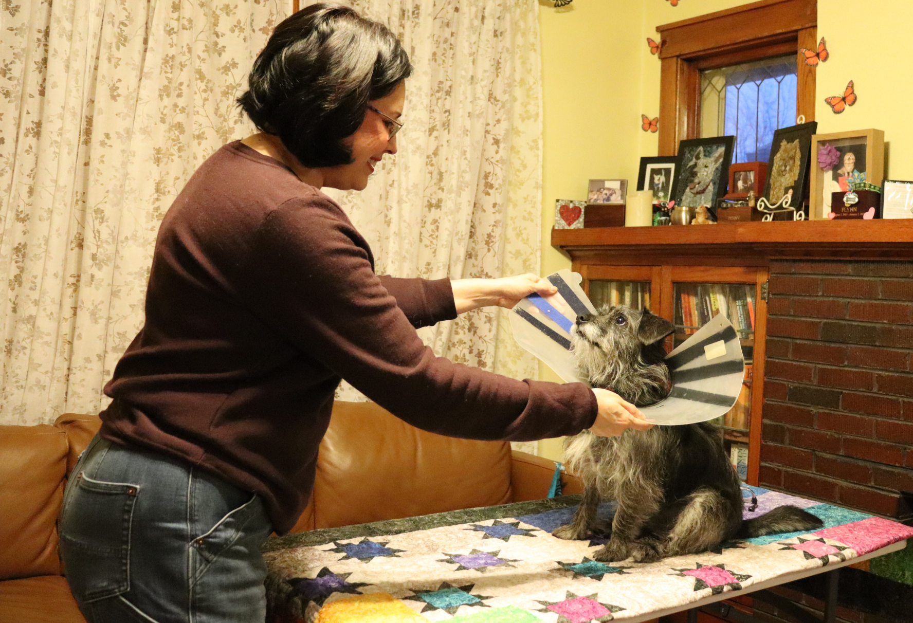 Woman helps dog with Elizabethan collar