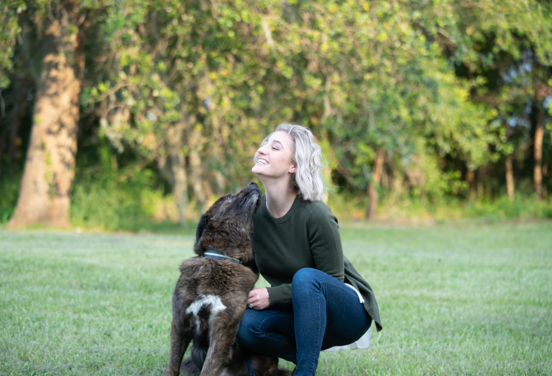 Woman being licked by dog