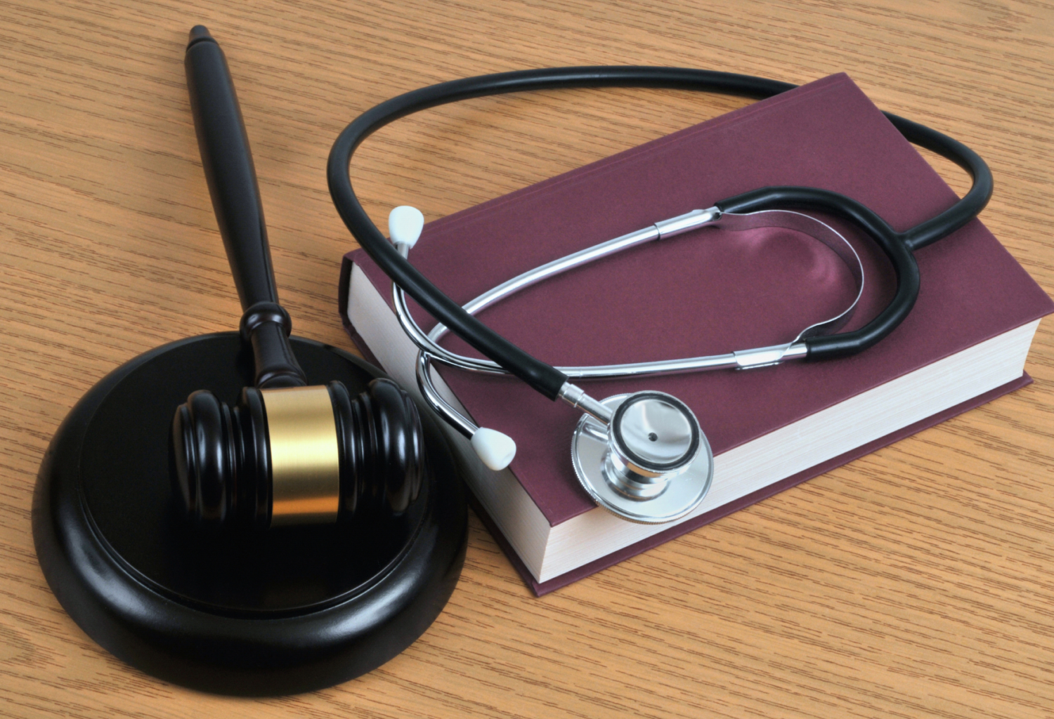 gavel and stethoscope on a book