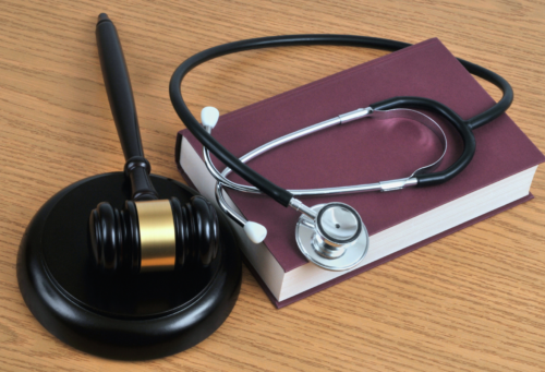 gavel and stethoscope on a book