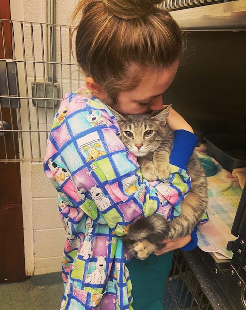 Shelby Woodward snuggling a patient in recovery.