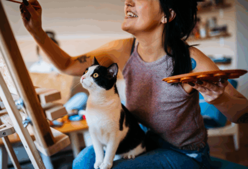 woman painting with cat