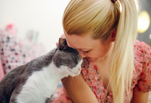 cat and woman snuggling