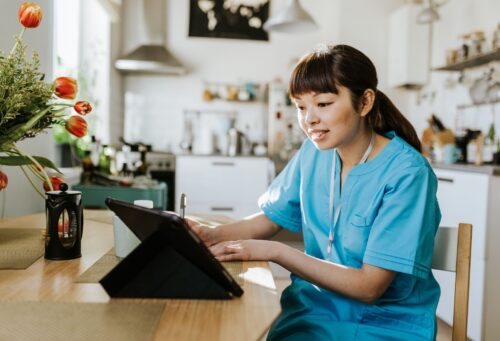 veterinarian on tablet in home