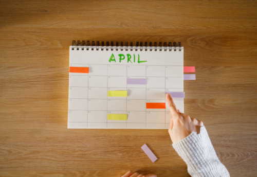 An April calendar sits on a wooden surface