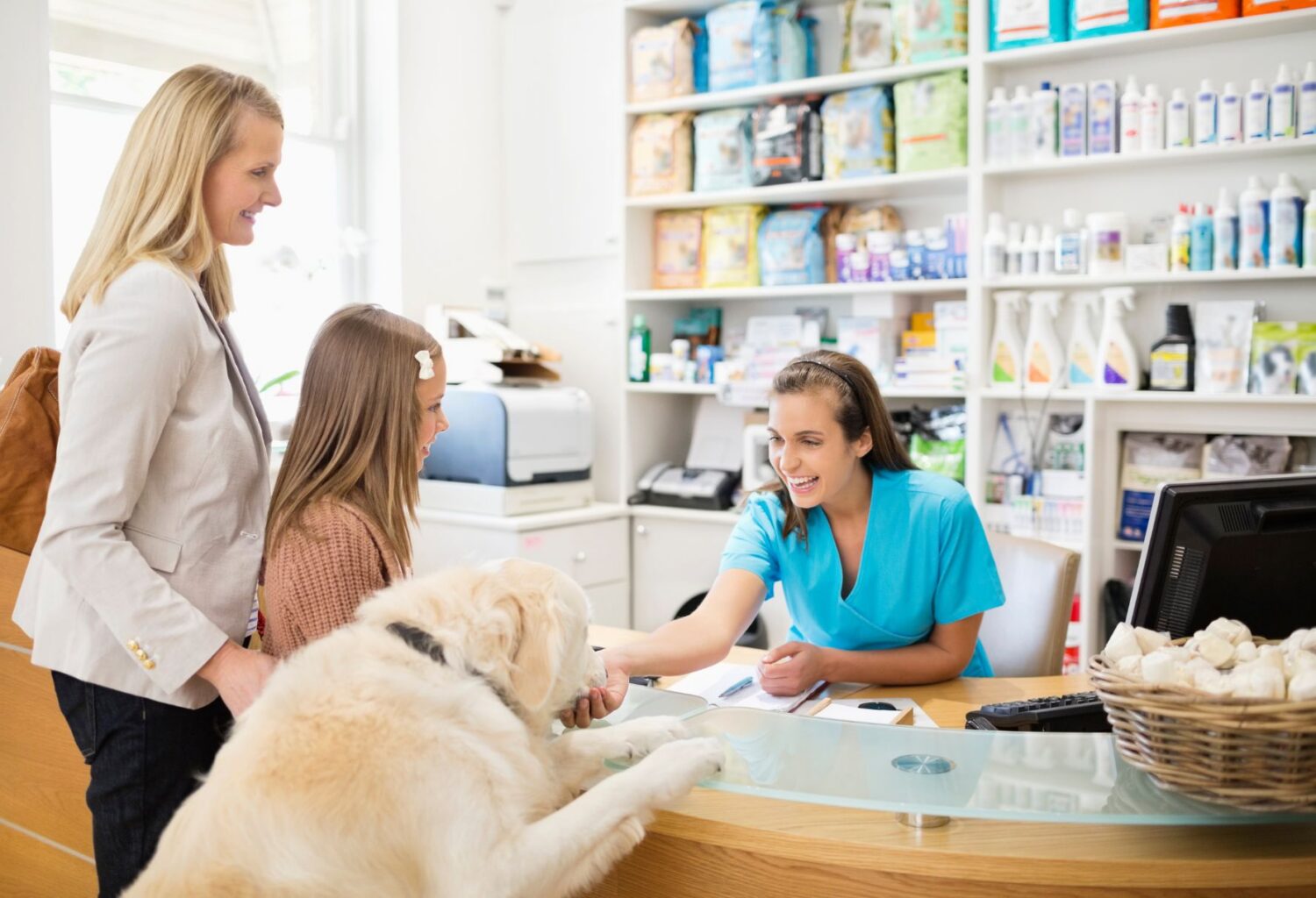 veterinary receptionist welcomes family with dog
