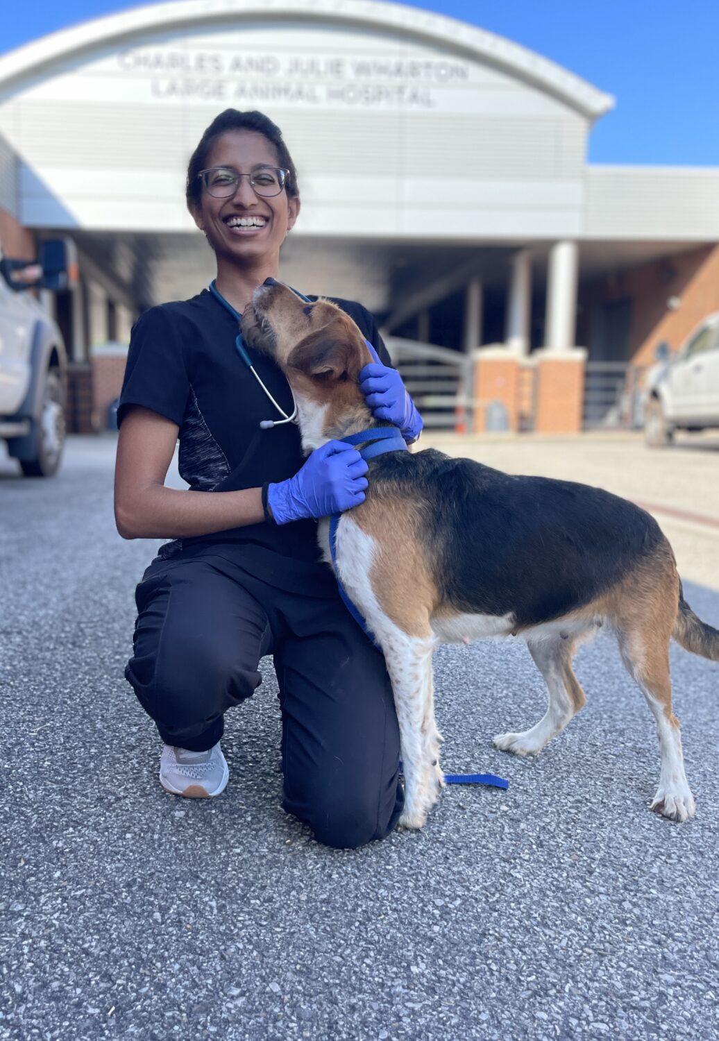 Student poses with dog at community clinic